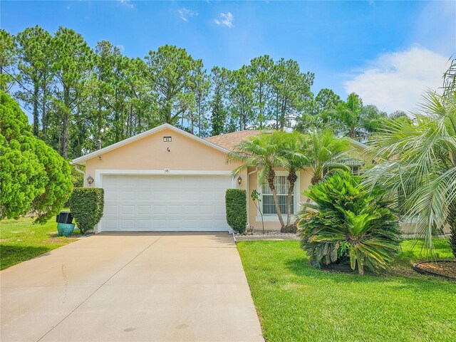 view of front of property featuring a front lawn and a garage