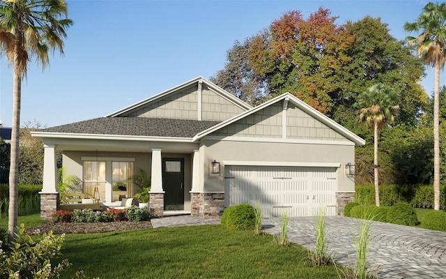 view of front of property featuring covered porch, a front yard, and a garage