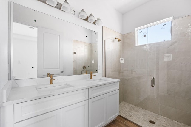 bathroom featuring vanity, wood-type flooring, and walk in shower