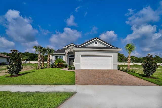 single story home featuring a garage and a front lawn