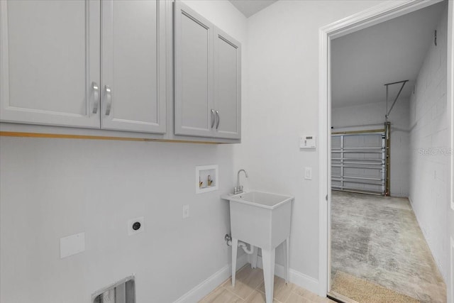 washroom featuring hookup for an electric dryer, cabinets, washer hookup, light tile patterned floors, and sink