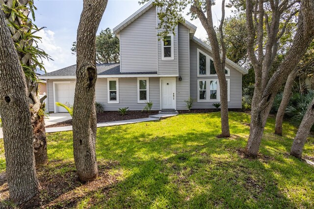 view of front property featuring a front yard and a garage