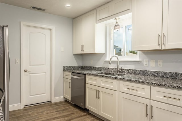 kitchen featuring dark hardwood / wood-style flooring, sink, stainless steel appliances, and white cabinets