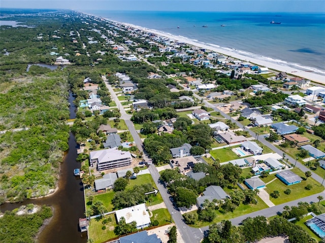 birds eye view of property featuring a water view and a view of the beach