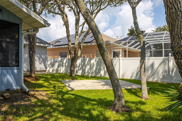 view of yard with a patio and glass enclosure