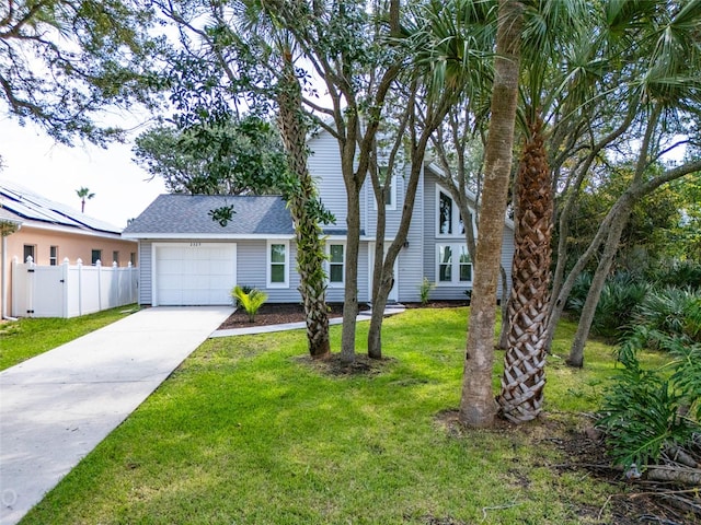 view of front of property featuring a garage and a front lawn