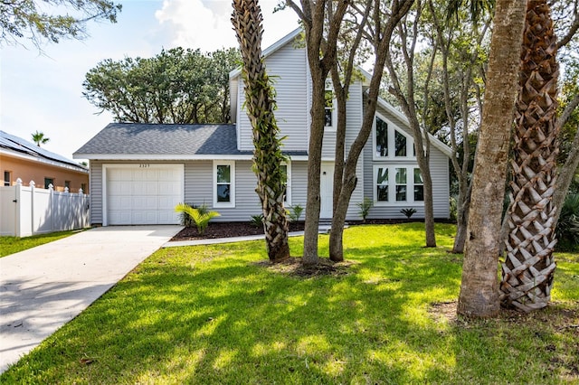 view of front of house with a garage and a front lawn