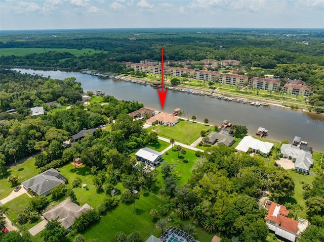 birds eye view of property with a residential view, a water view, and a view of trees