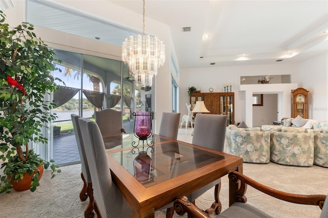 dining space with recessed lighting, a raised ceiling, light colored carpet, visible vents, and a chandelier