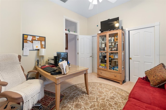 office space featuring visible vents, a ceiling fan, and light colored carpet