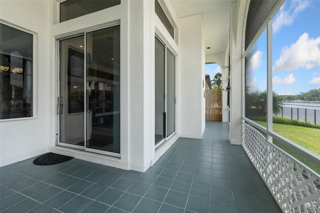 unfurnished sunroom with a water view and a wealth of natural light