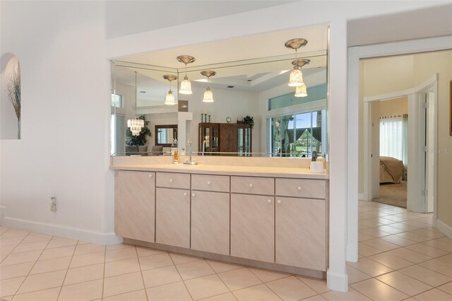 ensuite bathroom featuring ensuite bathroom, baseboards, vanity, and tile patterned floors