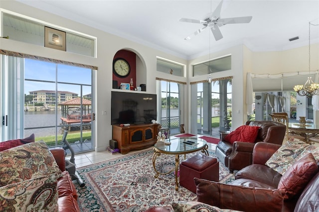 living room with ornamental molding, a wealth of natural light, and light tile patterned flooring