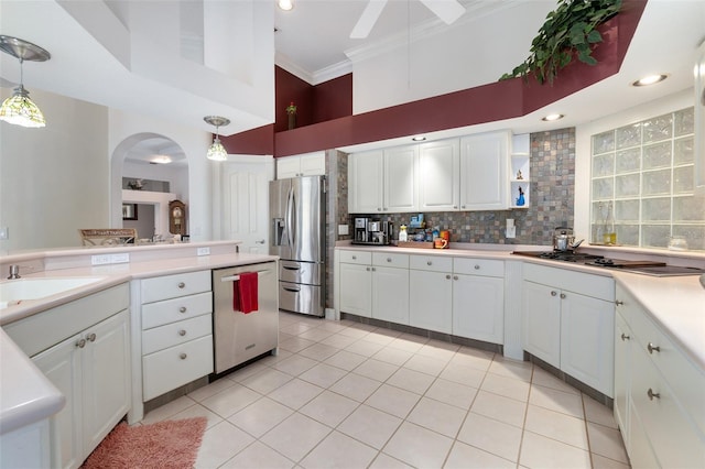 kitchen featuring stainless steel appliances, white cabinetry, and pendant lighting