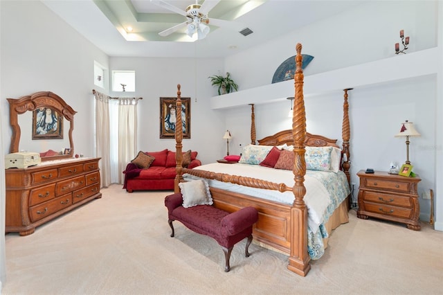 bedroom with visible vents, a ceiling fan, and light colored carpet