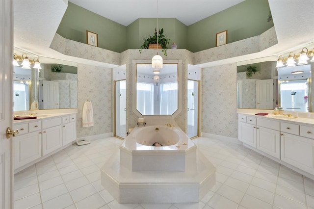 bathroom featuring a whirlpool tub, wallpapered walls, baseboards, and two vanities