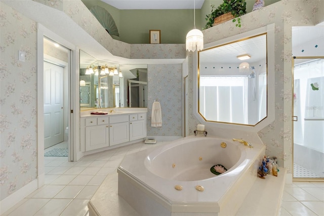 bathroom featuring a jetted tub, walk in shower, vanity, and wallpapered walls