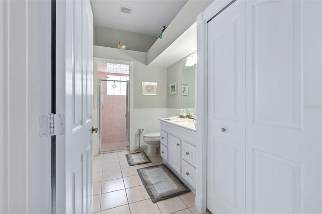 bathroom featuring visible vents, toilet, a wainscoted wall, tile patterned flooring, and vanity