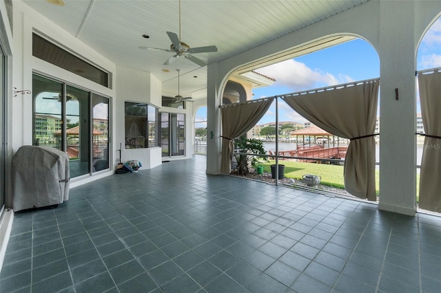 exterior space featuring a water view, wooden ceiling, and ceiling fan