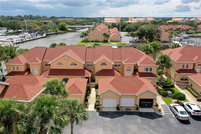 drone / aerial view with a water view and a residential view