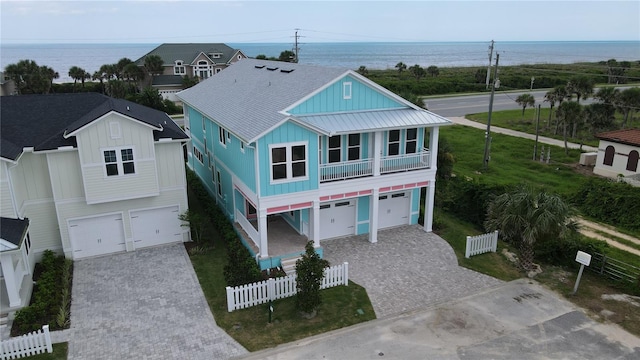 beach home featuring a water view and a garage