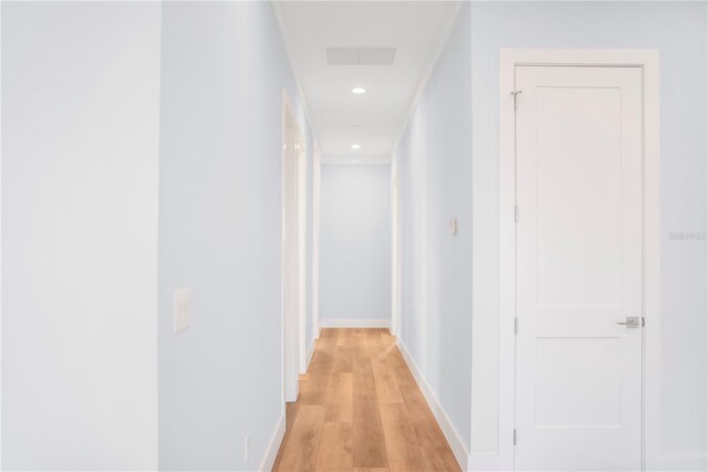 hallway with light hardwood / wood-style floors