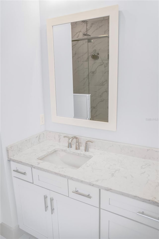 bathroom with a stall shower and vanity