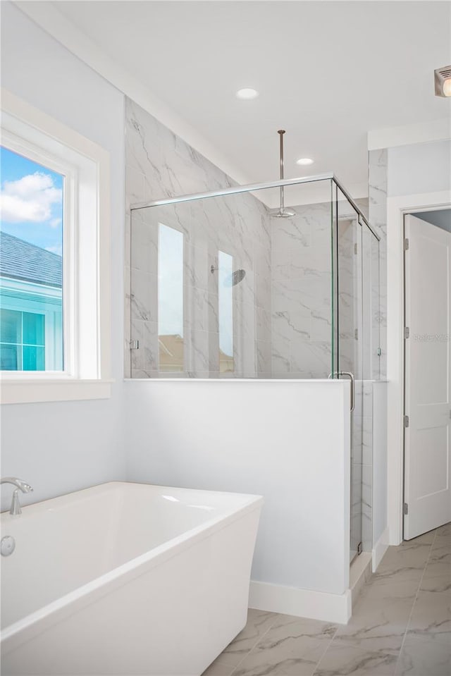 bathroom featuring separate shower and tub