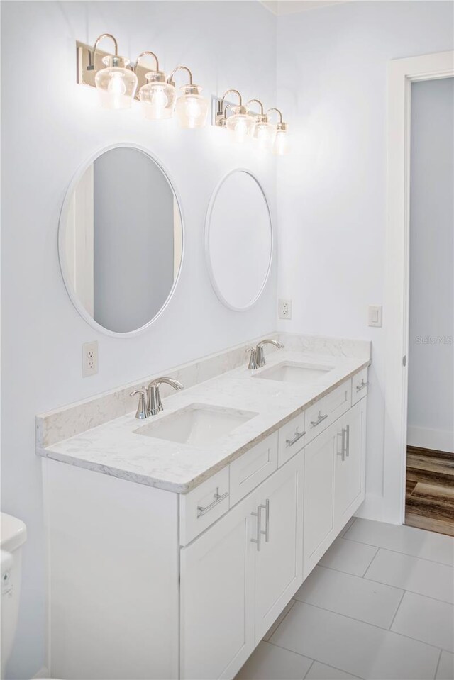 bathroom featuring vanity, toilet, and tile patterned flooring