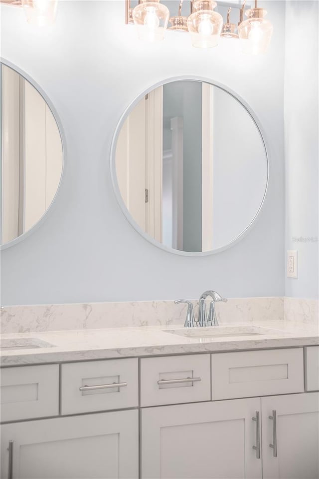 full bathroom with a sink and double vanity