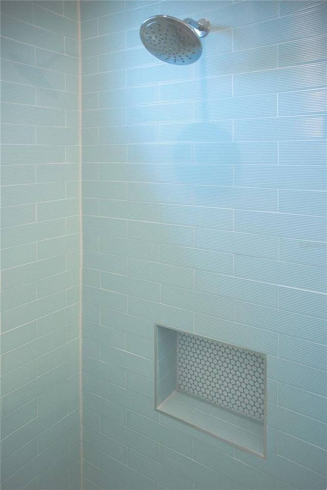 interior details with a tile shower