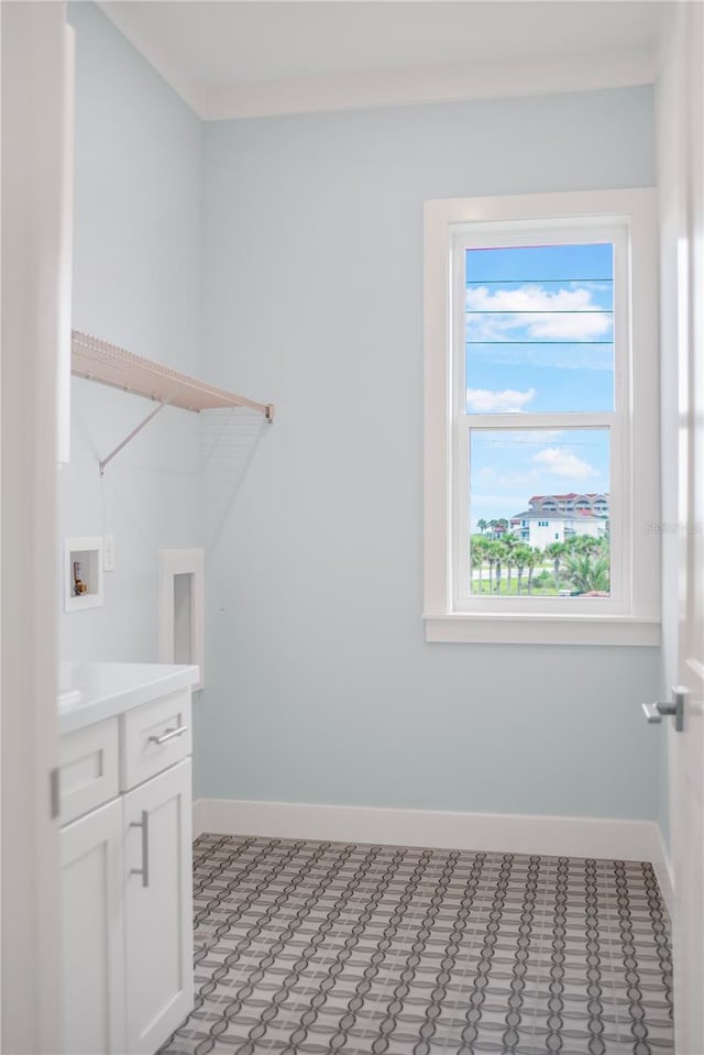 clothes washing area with hookup for a washing machine, hookup for an electric dryer, and cabinets