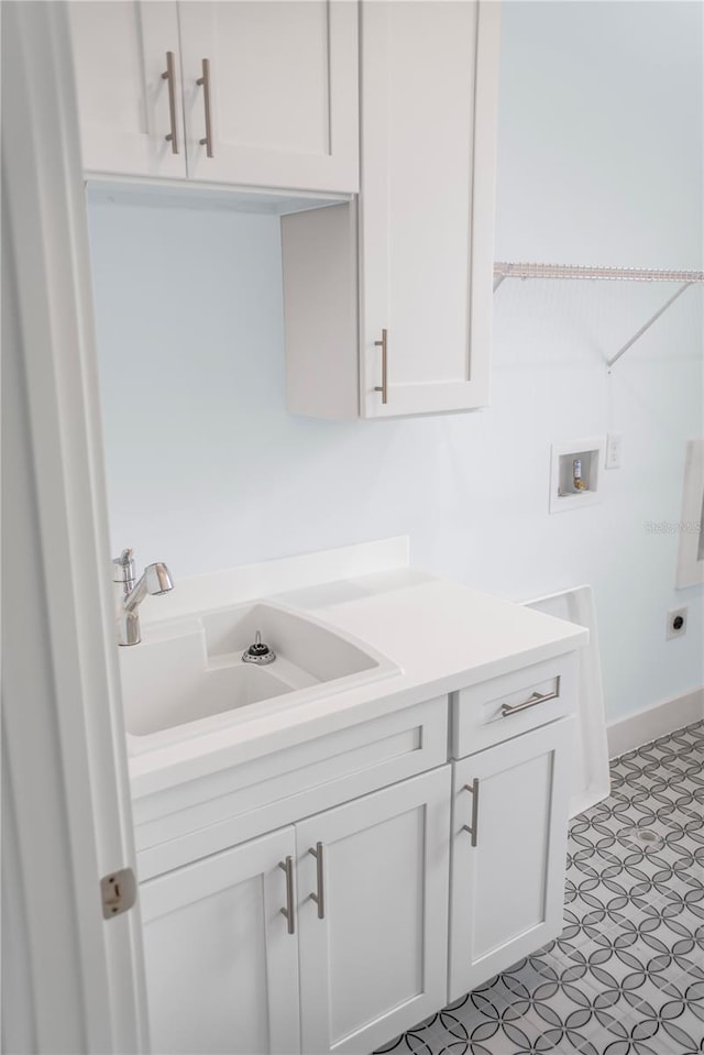 laundry area featuring washer hookup, cabinets, sink, and hookup for an electric dryer