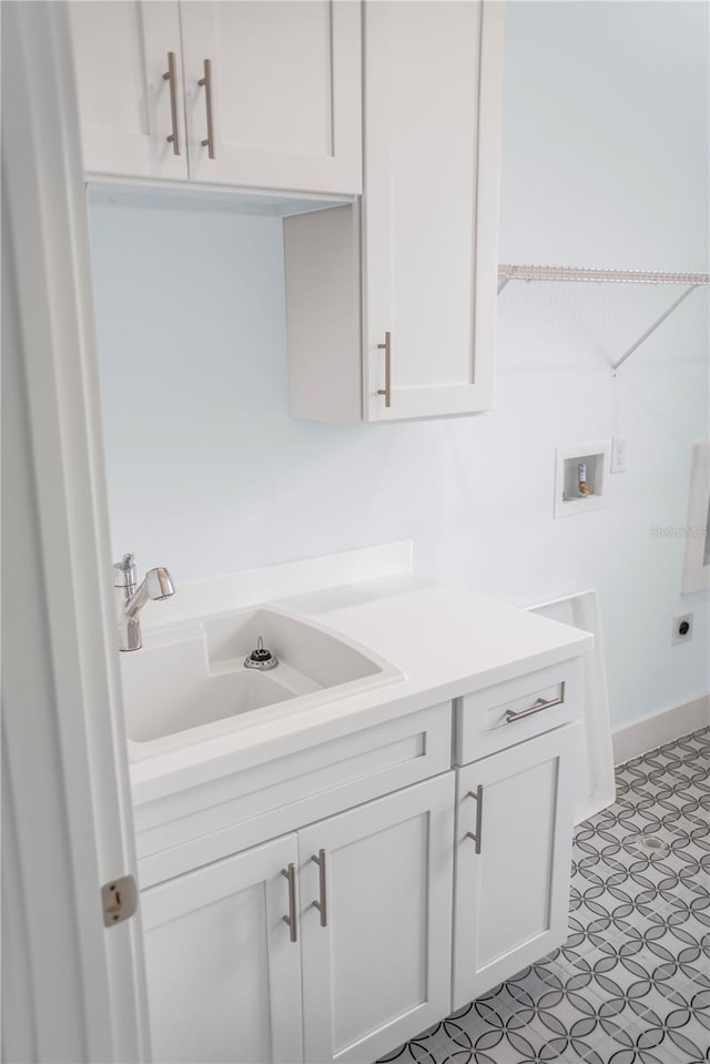 clothes washing area with washer hookup, a sink, cabinet space, and hookup for an electric dryer