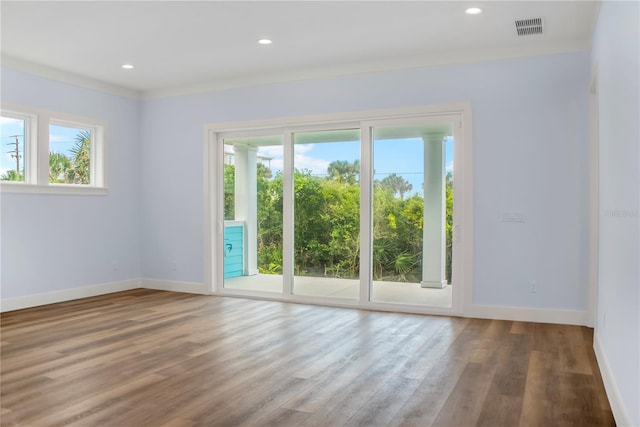 unfurnished room with baseboards, visible vents, wood finished floors, and recessed lighting