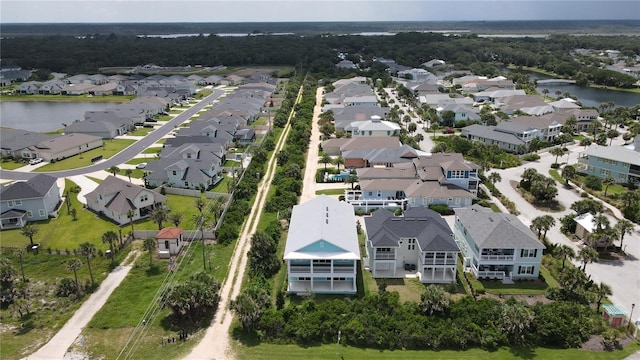 drone / aerial view with a water view and a residential view