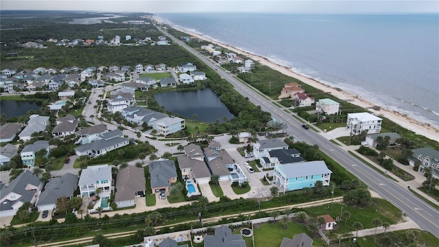 aerial view with a beach view, a water view, and a residential view