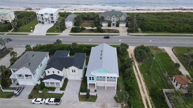 drone / aerial view with a water view and a view of the beach