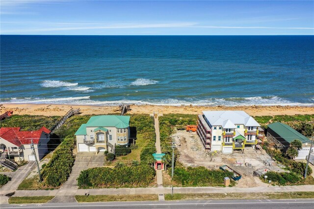 bird's eye view featuring a water view and a beach view