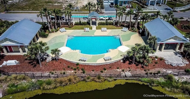 view of swimming pool with a water view and a patio