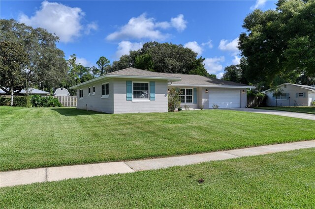 single story home featuring a front yard and a garage