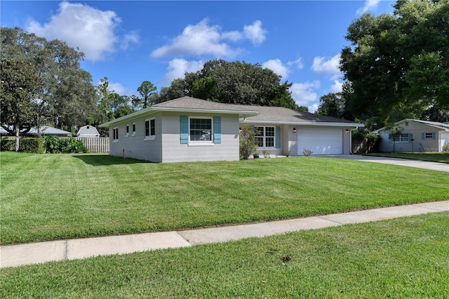 ranch-style house with an attached garage, concrete driveway, a front yard, and fence