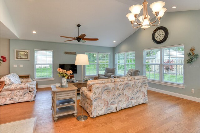 living area featuring high vaulted ceiling, ceiling fan with notable chandelier, recessed lighting, light wood finished floors, and baseboards