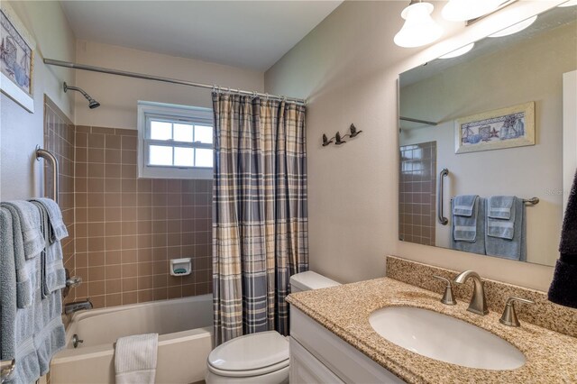 bathroom with toilet, vanity, and shower / bathtub combination with curtain