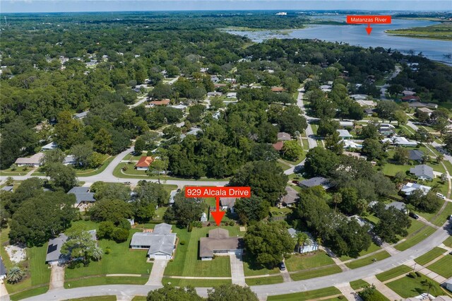 birds eye view of property with a forest view and a water view