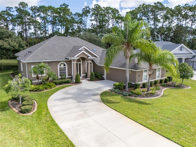 view of front of house featuring a front yard and a garage