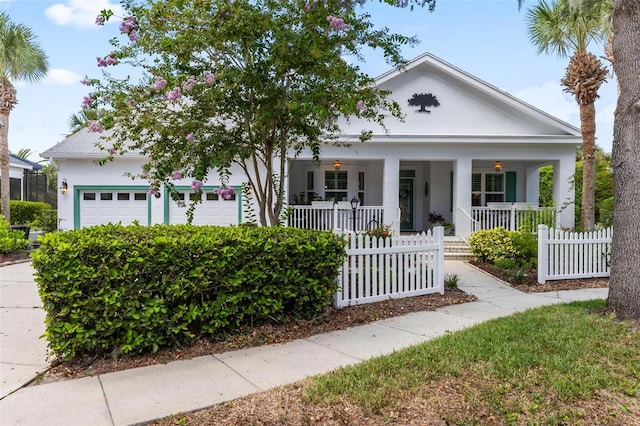 view of front of home featuring covered porch and a garage