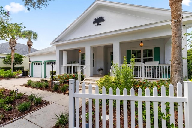 neoclassical / greek revival house featuring a garage and a porch