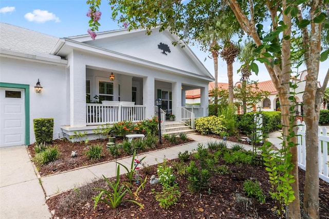 view of front of property with a porch and a garage