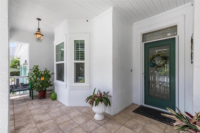 view of exterior entry with covered porch